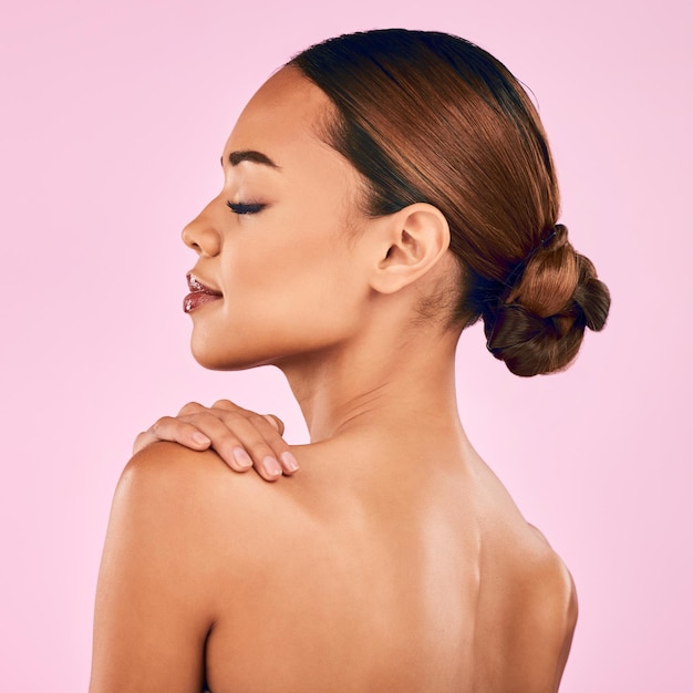 Woman face and profile natural beauty and skincare with cosmetic shine isolated on pink background Female model calm with makeup and dermatology skin glow and wellness with self love in studio