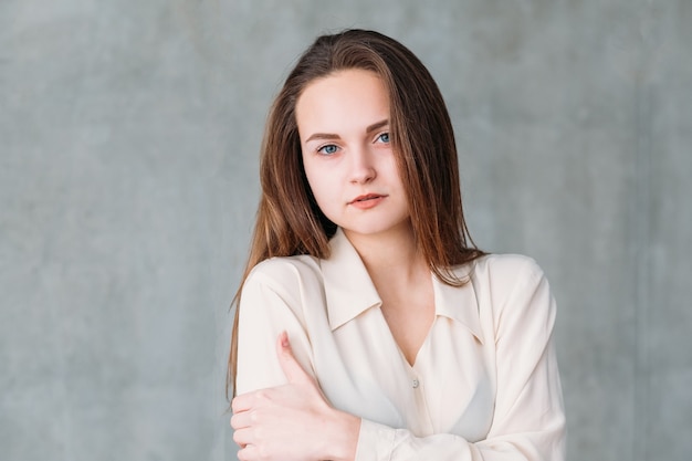 Woman facial expression. Young beautiful female looking wearily feeling cold