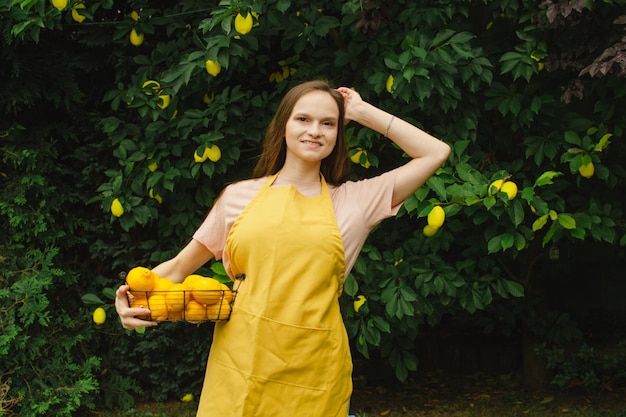 Woman farmer with a basket of lemons in her hands