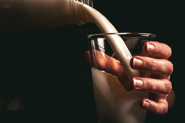 Woman farmer with a glass of milk. concept problems in the agricultural sector.