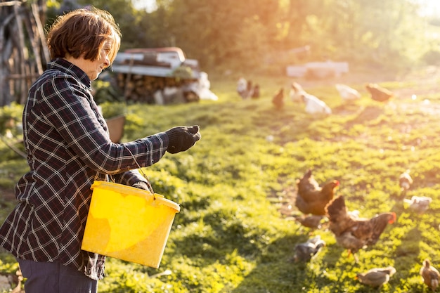 Woman feeding the chickens