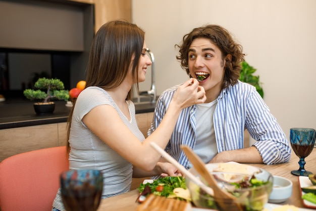 Woman feeding his husband at moren kitchen