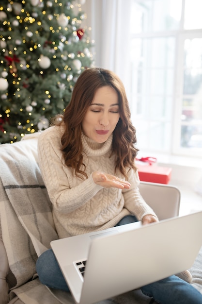 Woman feeling great while talking on videocall