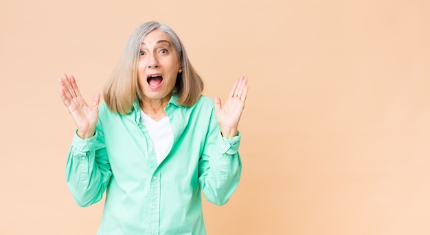 woman feeling happy, excited, surprised or shocked, smiling and astonished at something unbelievable