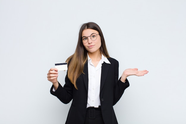 woman feeling puzzled and confused, doubting, weighting or choosing different options with funny expression