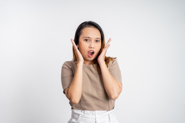 Woman feeling shocked and suprised over isolated background