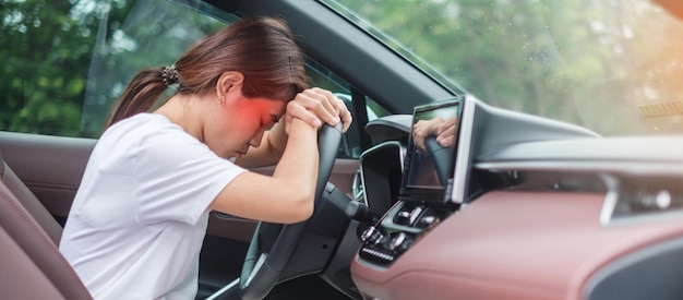 Woman feeling stress and angry during drive car long time Asian girl tired and fatigue having headache stop after driving car in traffic jam Sleepy stretching and drunk concept