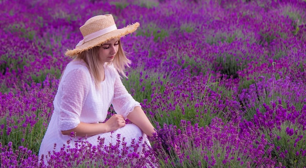 Woman in a field of lavender flowers in a white dress Ukraine