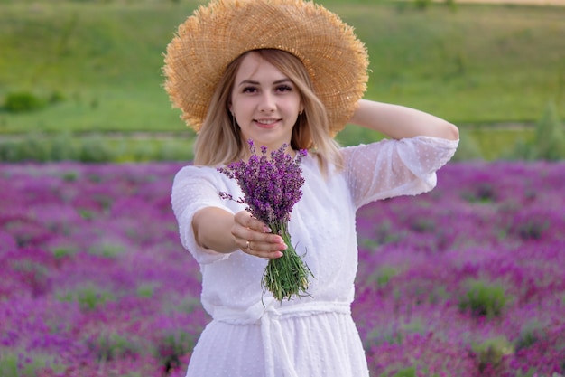 Woman in a field of lavender flowers in a white dress Ukraine