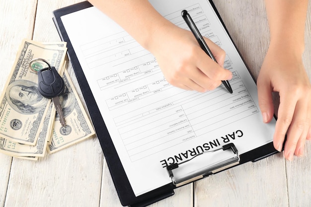 Woman filling in car insurance form at table