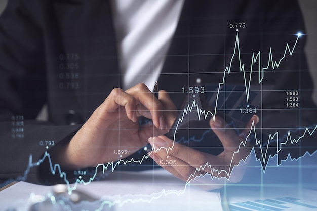 A woman financial trader in formal wear is checking the phone to sign the contract to invest money in stock market Internet trading and wealth management concept Forex hologram chart