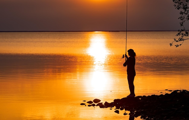 Woman fishing on Fishing rod spinning in Finland