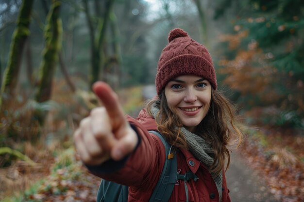 Woman on forest path pointing at camera