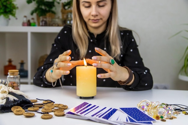 Woman fortune teller fortune telling on a candle Selective focus