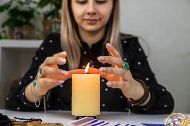 Woman fortune teller fortune telling on a candle Selective focus