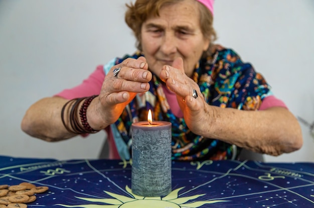 Woman fortune teller fortune telling on a candle Selective focus