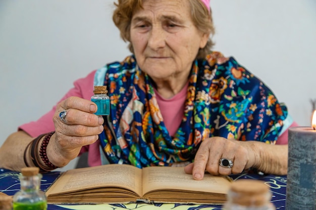 Woman fortune teller prepares a potion Selective focus