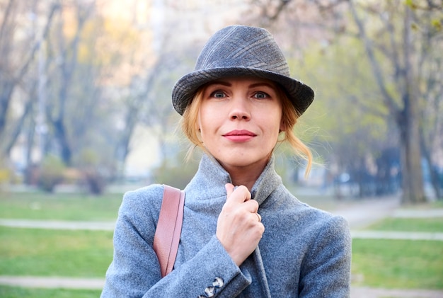 Woman of forty years old in coat and hat in spring