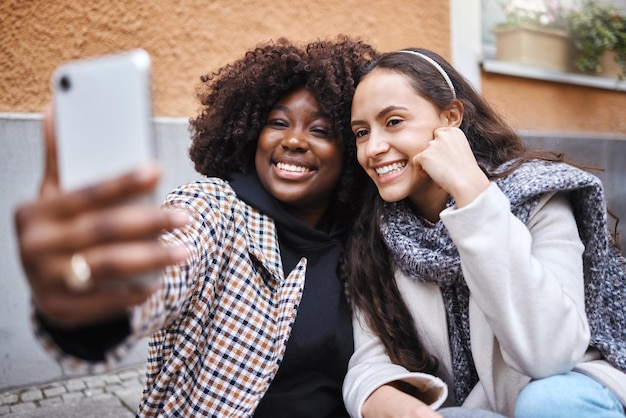 Woman friends and selfie smile in the city for friendship memory social media or profile picture Happy women smiling for photo online post or vlog in travel journey or trip in a urban town