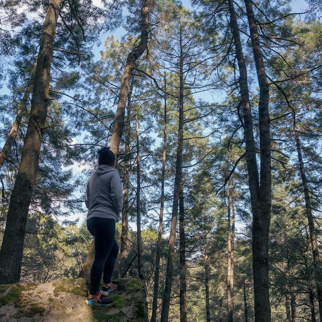 Woman in front of the forest