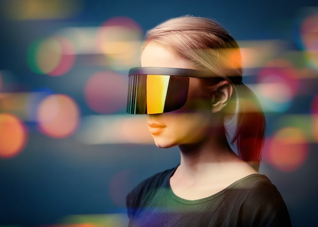 Woman in futuristic glasses on grey space