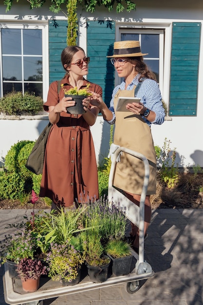 Woman gardener consults buyer about a plant care