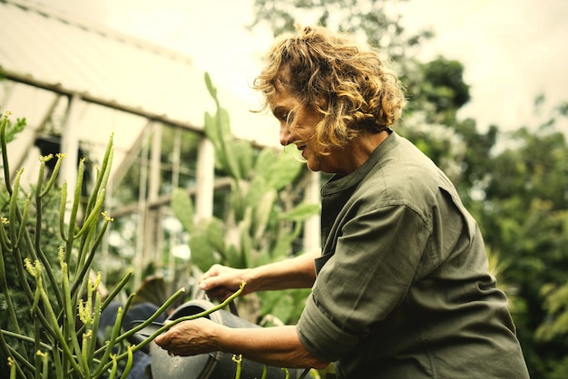 Woman gardening in her greenhouse