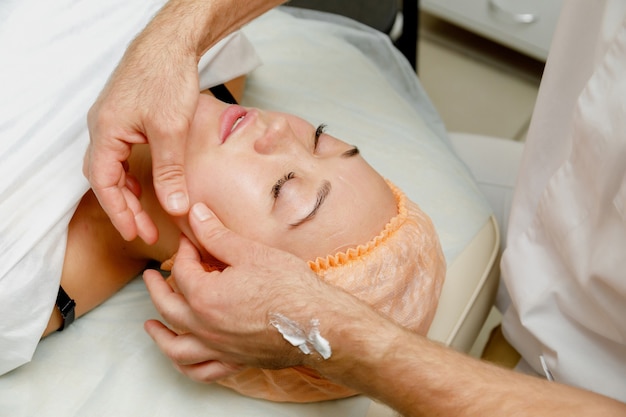 Woman getting face massage. Spa treatment in beauty salon