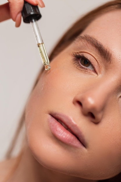 A woman getting an injection from a syringe.