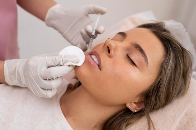 Woman getting lip filler close up