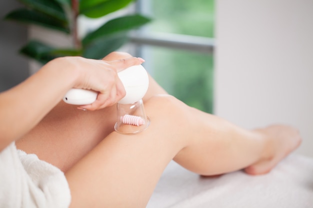 Woman getting LPG massage for skin care in beauty studio