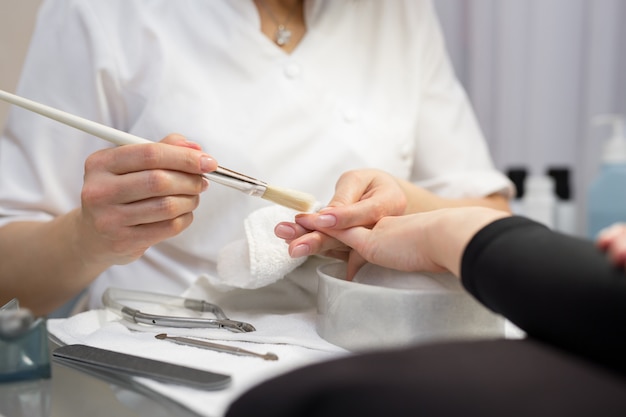 Woman getting nail manicure