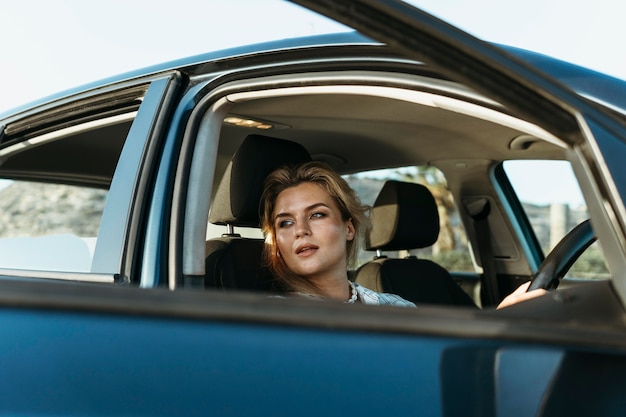 Woman getting out of car