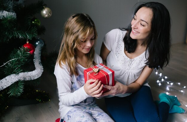 "Woman giving gift to daughter"