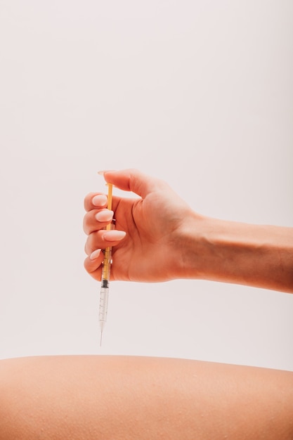 Woman giving herself an injection against diabetes