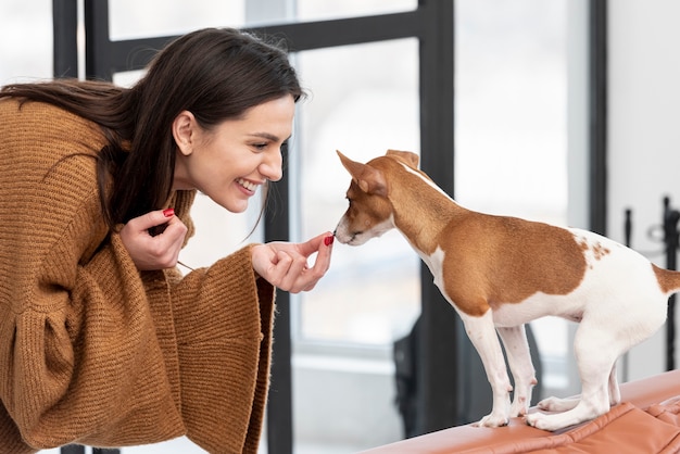 Woman giving treats to her dog