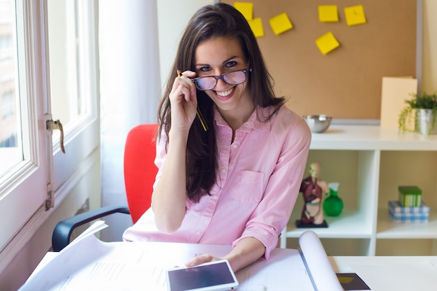 Woman in glasses holding pad