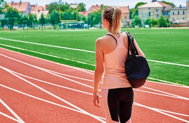 Woman going on fitness training with sport bag