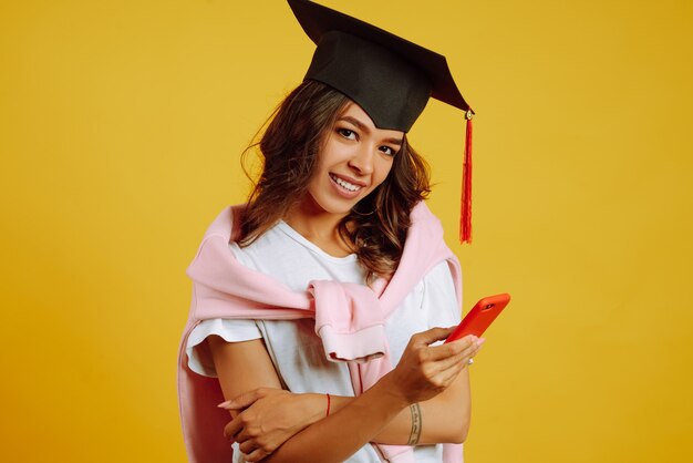 woman in graduation using smartphone