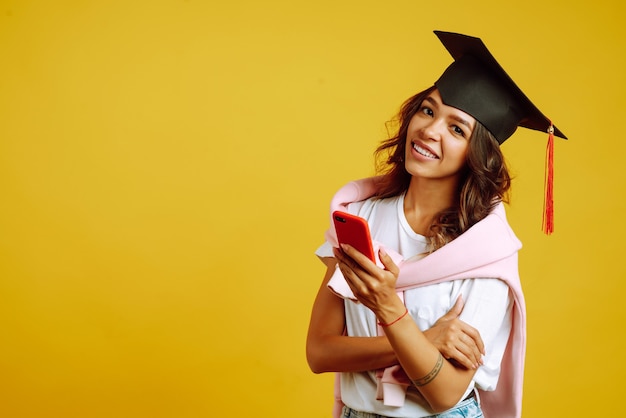 woman in graduation using smartphone