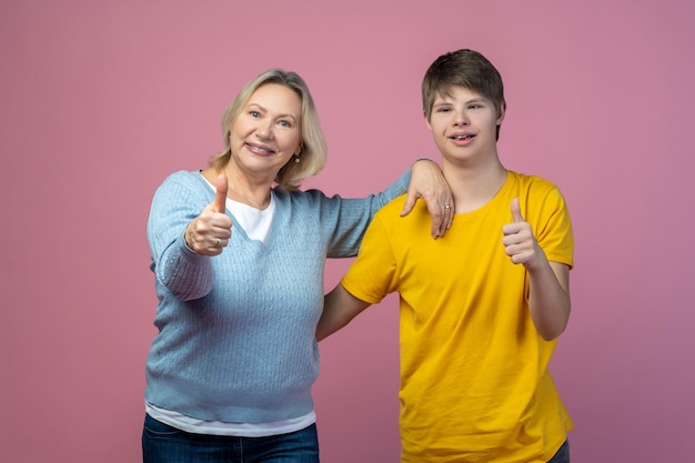 Woman and guy showing ok sign to camera