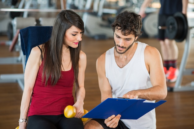 Woman in a gym reading her schedule