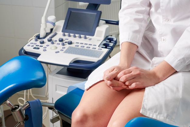 Woman at gynecologist office sitting and waiting for a doctor with test results