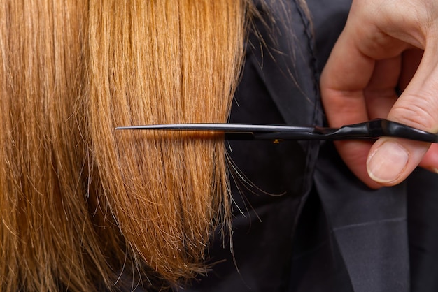 Woman hair care hairdresser making hairstyle to young girl in beauty salon