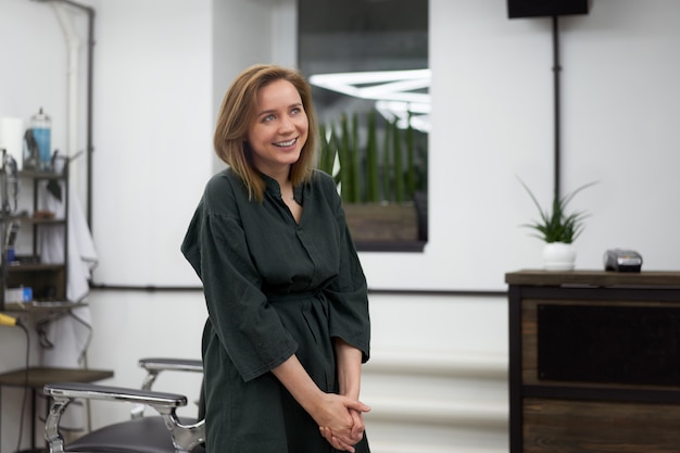 Woman hairdresser standing in barbershop