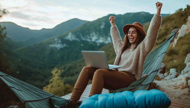 Photo a woman in a hammock with a laptop in her hand