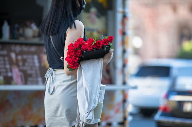 Woman hand beautiful roses in the streetxA