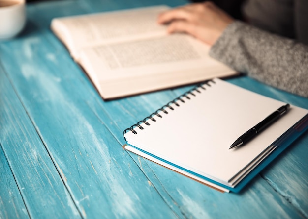 Woman hand book with notepad