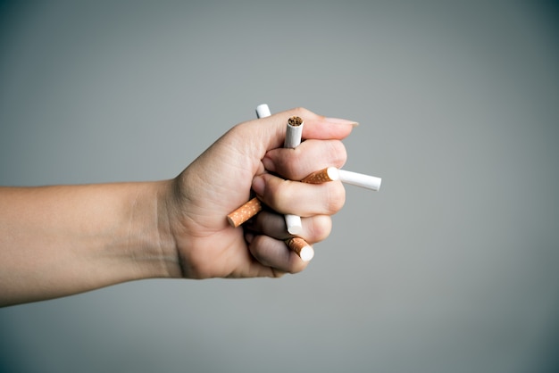 Woman hand breaking cigarettes. World No Tobacco Day