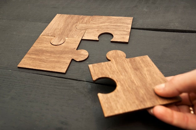 woman hand connecting puzzles to each other